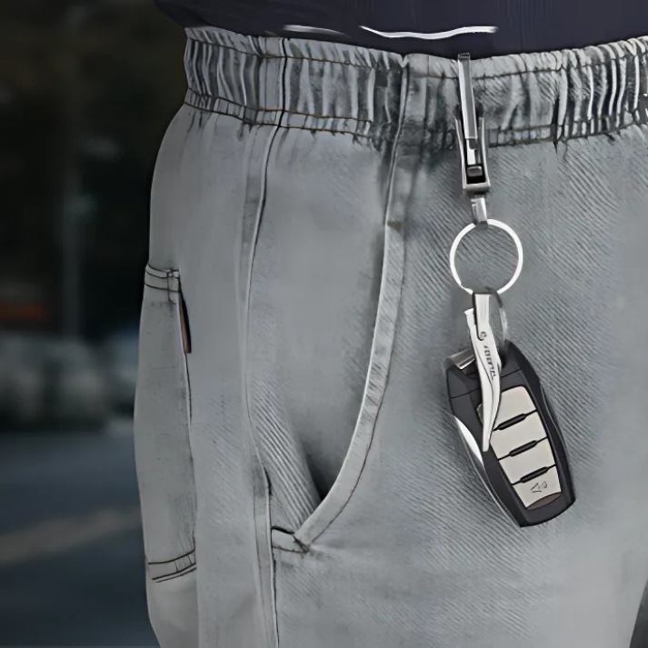 DUROX foldable splinter removal tweezers on a keyring, securely attached to a pant’s belt loop for convenient access.